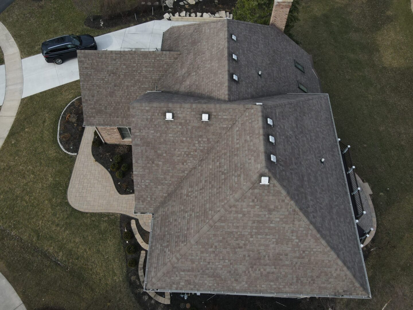 A bird 's eye view of a house with two roofs.