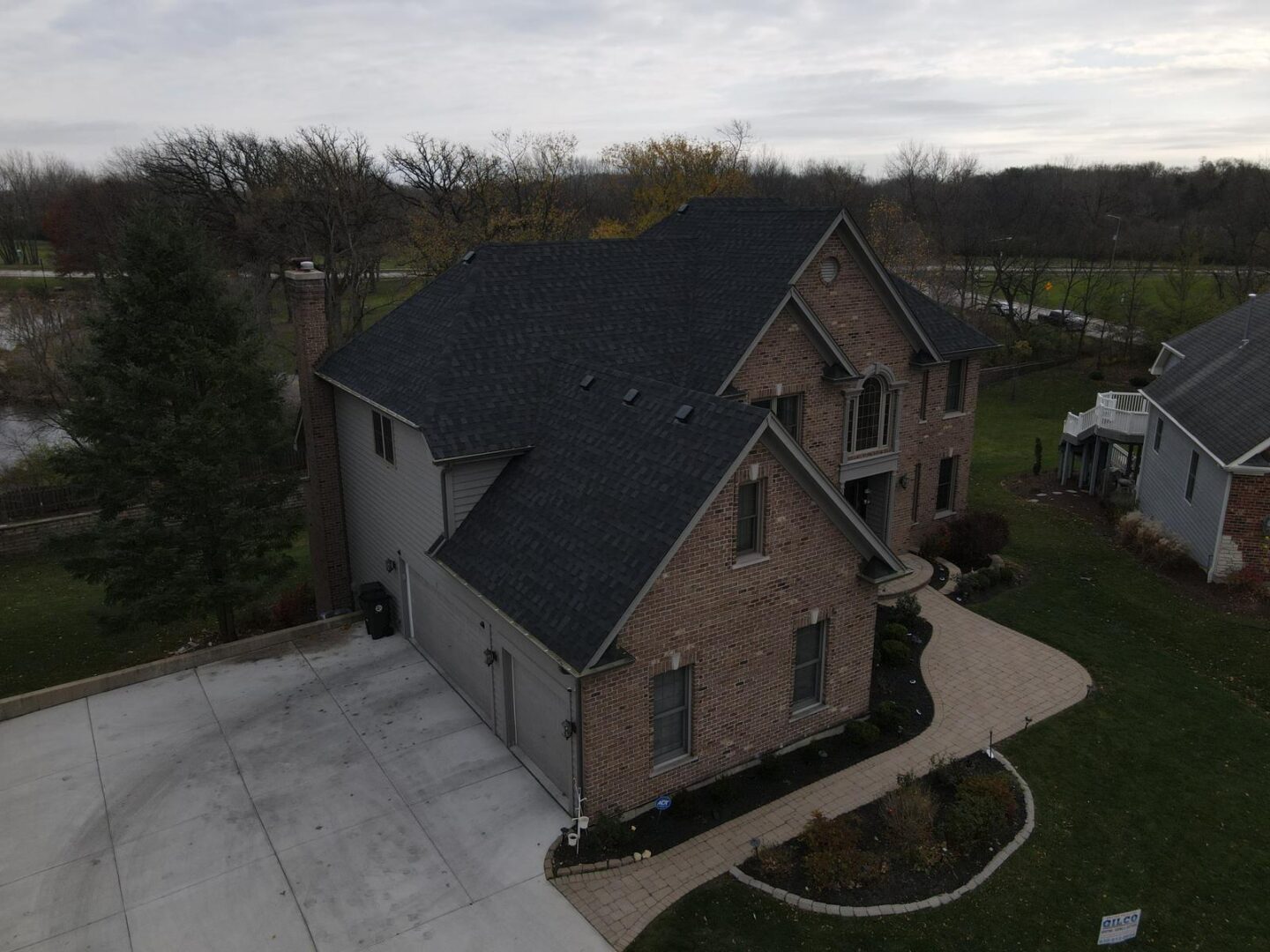 A large brick house with a black roof.